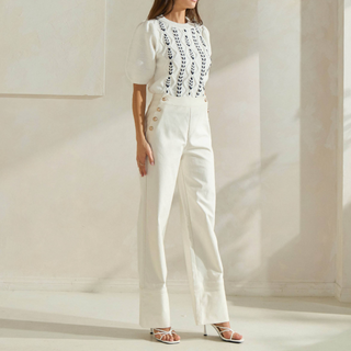 Ivory high-rise button front trousers with gold button detail and straight-leg fit