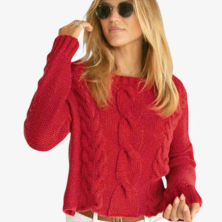 Woman wearing Aspen Crew Sweater in red cable knit with long sleeves and crew neckline
