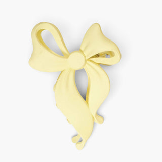 Butter yellow bow-shaped hair claw clip on a white background