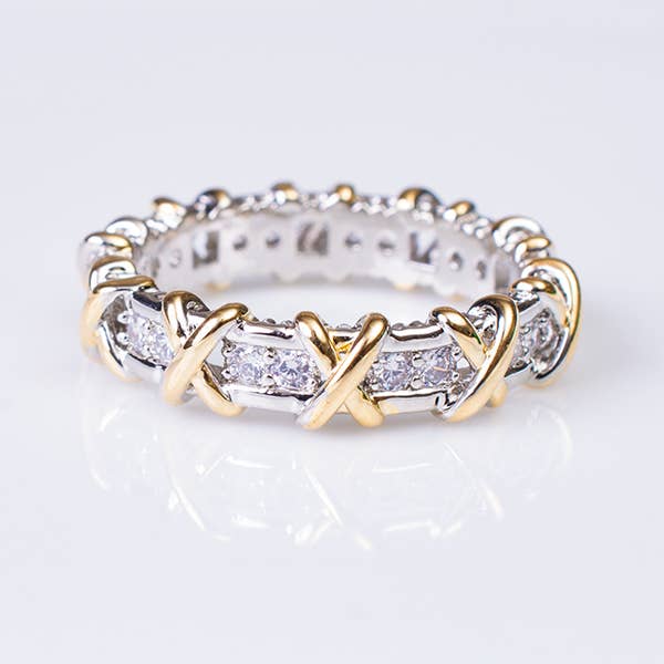 Two tone X channel set ring with gold X and crystal designs in silver channel setting.